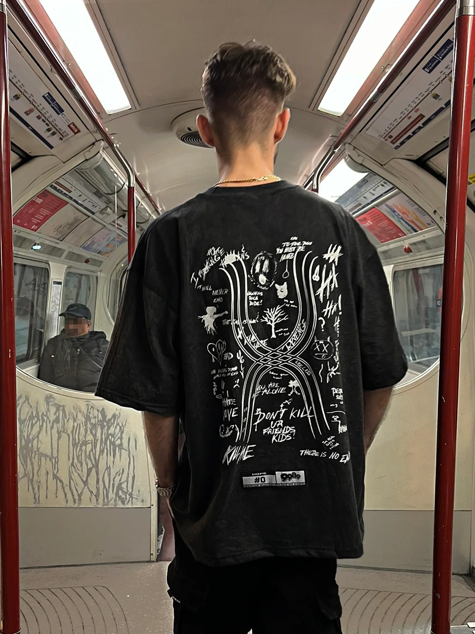 MODELO DE ESPALDAS EN METRO LONDRES CON CAMISETA OVERSIZE 9989 "HOPE" TRIBUTE DESIGN XXXTENTACION